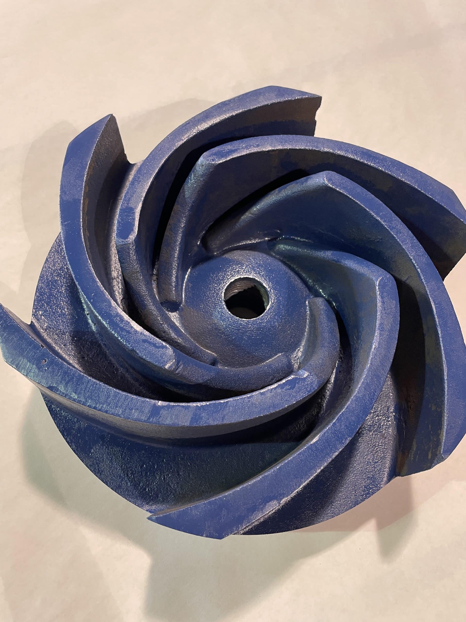 An impeller spray painted blue