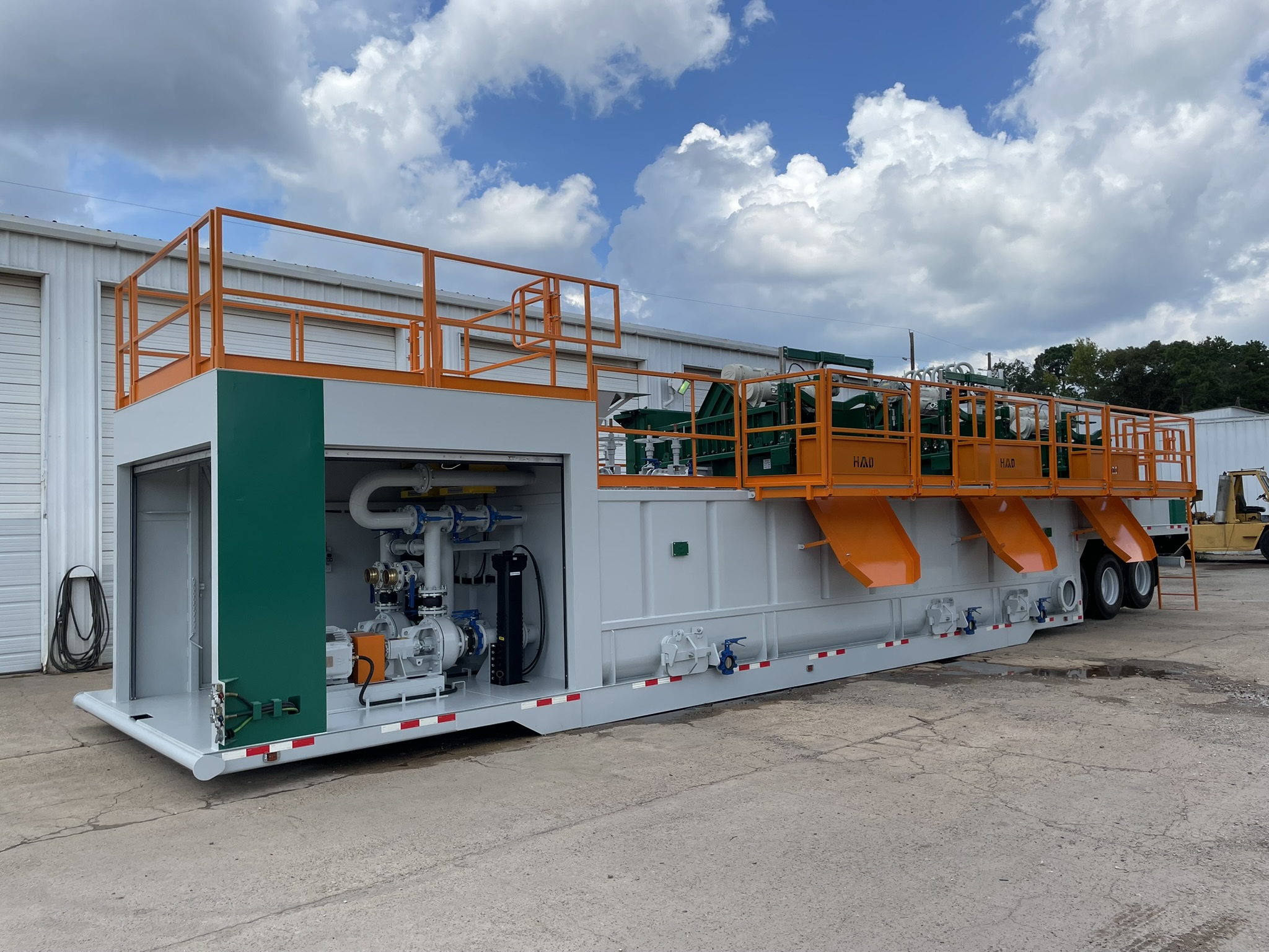 Custom Triflo Rockover dewatering system with roll-up pump-enclosure doors open